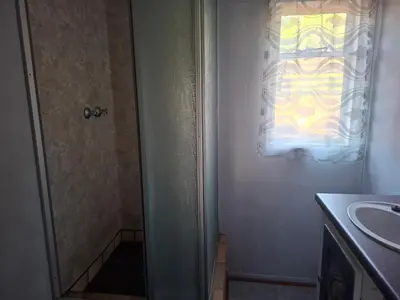 a bathroom with a shower and a sink at AmaZeng farmhouse Mustang in Lydenburg