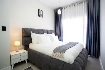 a bedroom with a large bed and a window at Waterfall Midrand Lifestyle Luxe in Midrand