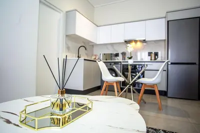 a kitchen with a table with a vase on it at Waterfall Midrand Lifestyle Luxe in Midrand