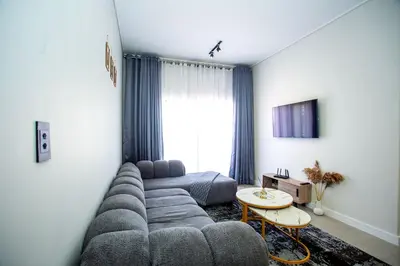 a living room with a couch and a table at Waterfall Midrand Lifestyle Luxe in Midrand