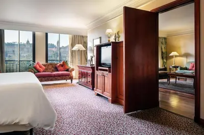a hotel room with a bed and a flat screen tv at CT Hotel in Pretoria