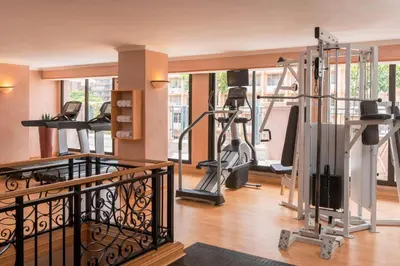 a gym with treadmills and elliptical machines at CT Hotel in Pretoria