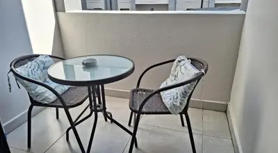 a small table and two chairs and a table and chairs at The Convenient Space in Midrand