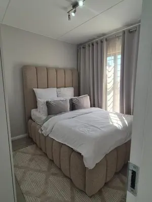 a large bed in a room with a window at Village Vista at Atlasville 10km from OR Tambo in Boksburg