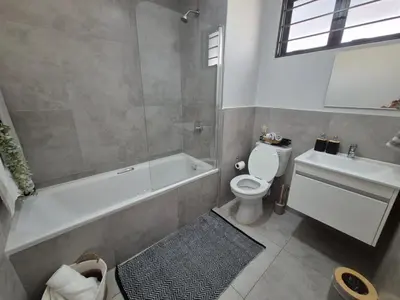 a bathroom with a tub and a toilet and a sink at Village Vista at Atlasville 10km from OR Tambo in Boksburg