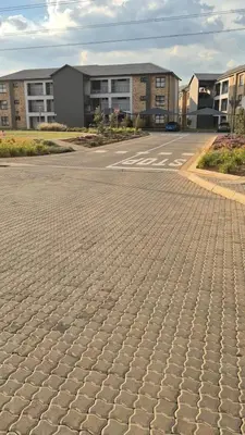 an empty parking lot in front of a building at Village Vista at Atlasville 10km from OR Tambo in Boksburg