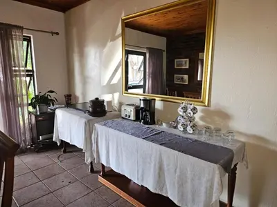 two tables in a room with a mirror at Steendal Guest House in Polokwane