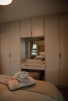 a bedroom with a bed with a mirror at Plekkie Sonder Die See in Centurion