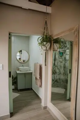a bathroom with a sink and a mirror at Plekkie Sonder Die See in Centurion
