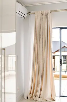 a curtain in a room with a window at 2 Bedroom 2 Bathroom Executive Suite in Midrand