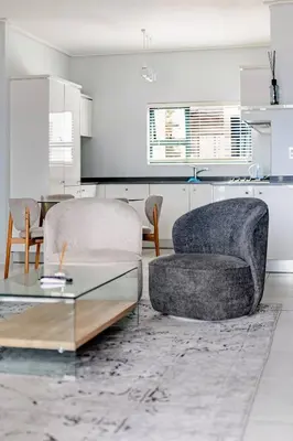 a living room with a chair and a table at 2 Bedroom 2 Bathroom Executive Suite in Midrand
