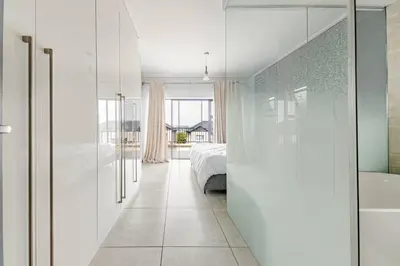 a bedroom with a bed and a bath tub next to a bed sidx sidx sidx at 2 Bedroom 2 Bathroom Executive Suite in Midrand
