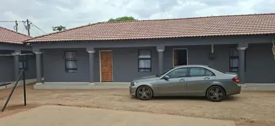a silver car parked in front of a house at Magoveni Accommodation