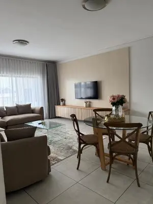 a living room with a table and a couch at AAAA Property Management in Midrand