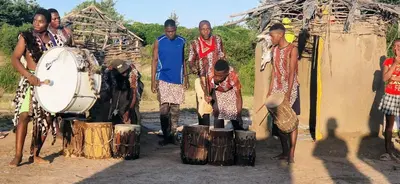 a group of people standing in front of a drum at Phumula Bushvilla in Phalaborwa