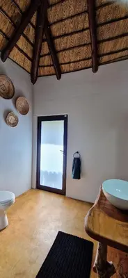 a large room with a large window and a toilet at Phumula Bushvilla in Phalaborwa