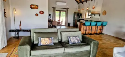 a living room with a couch with two pillows at Phumula Bushvilla in Phalaborwa