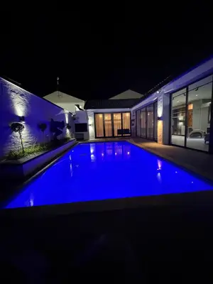 a swimming pool at night in a house at Villa On 59 in Giyani