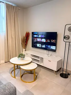 a living room with a tv and a table at Unit 87 at Circa Lynwood in Pretoria