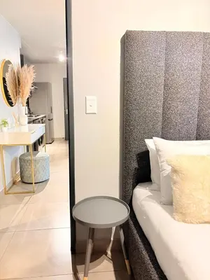 a living room with a couch and a table at Unit 87 at Circa Lynwood in Pretoria