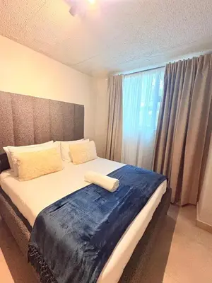 a bedroom with a large bed with a large window at Unit 87 at Circa Lynwood in Pretoria