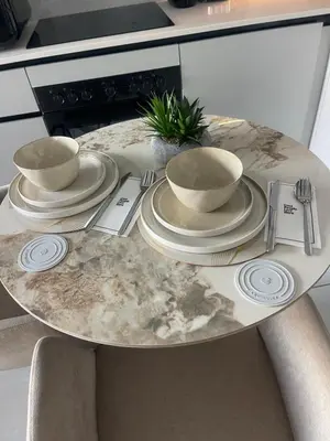 a table with three cups and plates on it at The Blyde Luxury Apartment in Pretoria