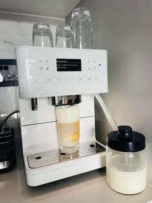 a coffee maker with a glass of milk at The Blyde Luxury Apartment in Pretoria