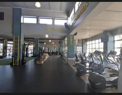 a gym with lots of treadmills and exercise bikes at The Blyde Luxury Apartment in Pretoria