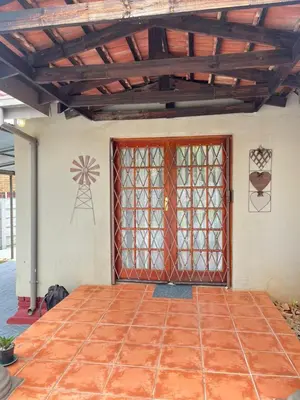 a front door of a house with a windmill on the wall at 14 Isabel in Centurion
