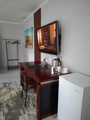a desk with a television on top of it at 14 Isabel in Centurion