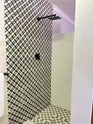 a shower in a bathroom with a black and white pattern at 14 Isabel in Centurion