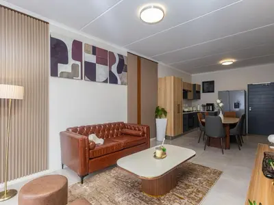 a living room with a couch and a table at Woodland Haven in Midrand