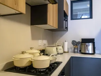 a kitchen with a stove with pots and pans on it at Woodland Haven in Midrand