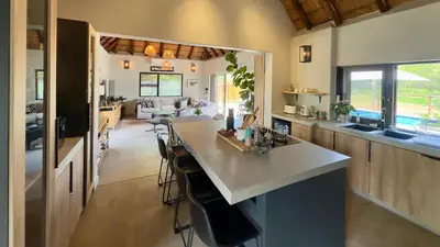a kitchen with a island in the middle of a room at WildlifeEstateVilla-Pool-Boma-Bushlife in Hoedspruit