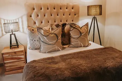 a bedroom with a bed with pillows on it at WildlifeEstateVilla-Pool-Boma-Bushlife in Hoedspruit