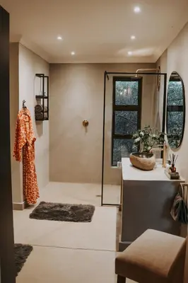 a room with a shower with a table and a mirror at WildlifeEstateVilla-Pool-Boma-Bushlife in Hoedspruit