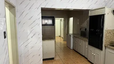a large kitchen with white counter tops and appliances at Entire Premises ideal for large groups and reunions in Pretoria