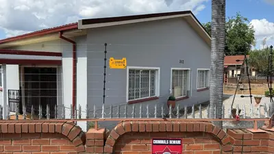 a house with a fence in front of it at Entire Premises ideal for large groups and reunions in Pretoria