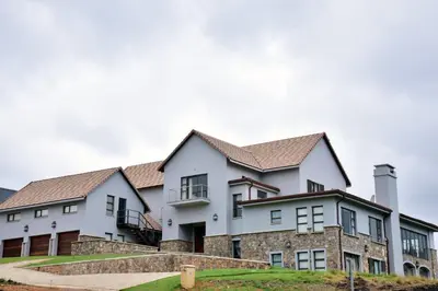 an image of a large white house at Deluxe Suite at in Highland Gate Golf and Trout Estate 1135 in Dullstroom