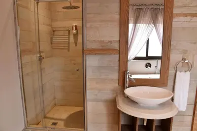 a bathroom with a sink and a shower at Deluxe Suite at in Highland Gate Golf and Trout Estate 1135 in Dullstroom