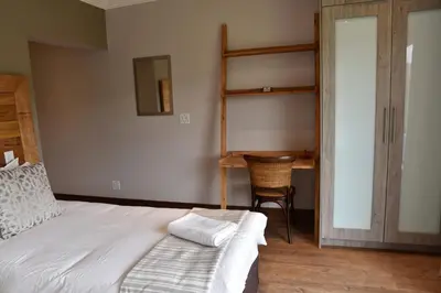 a bedroom with a bunk bed and a desk at Deluxe Suite at in Highland Gate Golf and Trout Estate 1135 in Dullstroom