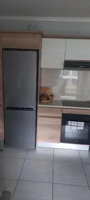 a kitchen with a refrigerator and a stove at Waterfall Midrand in Northdene