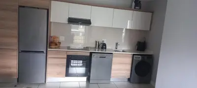 a kitchen with a refrigerator and a dishwasher at Waterfall Midrand in Northdene