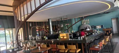 a dining room with a bar and chairs at Waterfall Midrand in Northdene