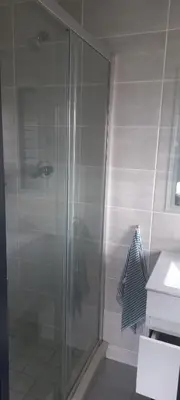 a shower with a glass door in a bathroom at Waterfall Midrand in Northdene