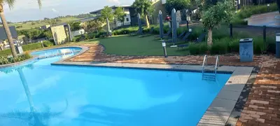 a large blue swimming pool in a resort at Waterfall Midrand in Northdene