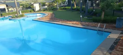 an overhead view of a large blue swimming pool at Waterfall Midrand in Northdene