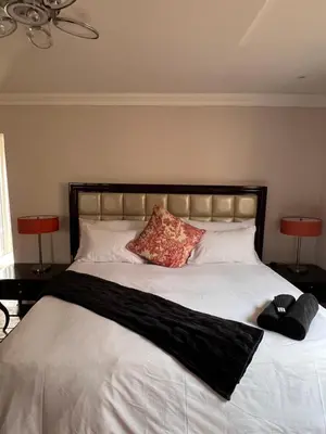 a large white bed with two pillows and two lamps at MorningMist Boutique 27 Dawie de Villiers Room 3 in Centurion