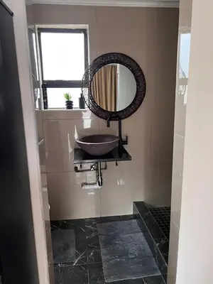 a bathroom with a sink and a mirror on the wall at MorningMist Boutique 27 Dawie de Villiers Room 2 in Centurion