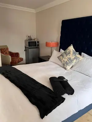 a bedroom with a bed with black towels on it at MorningMist Boutique 27 Dawie de Villiers Room 2 in Centurion